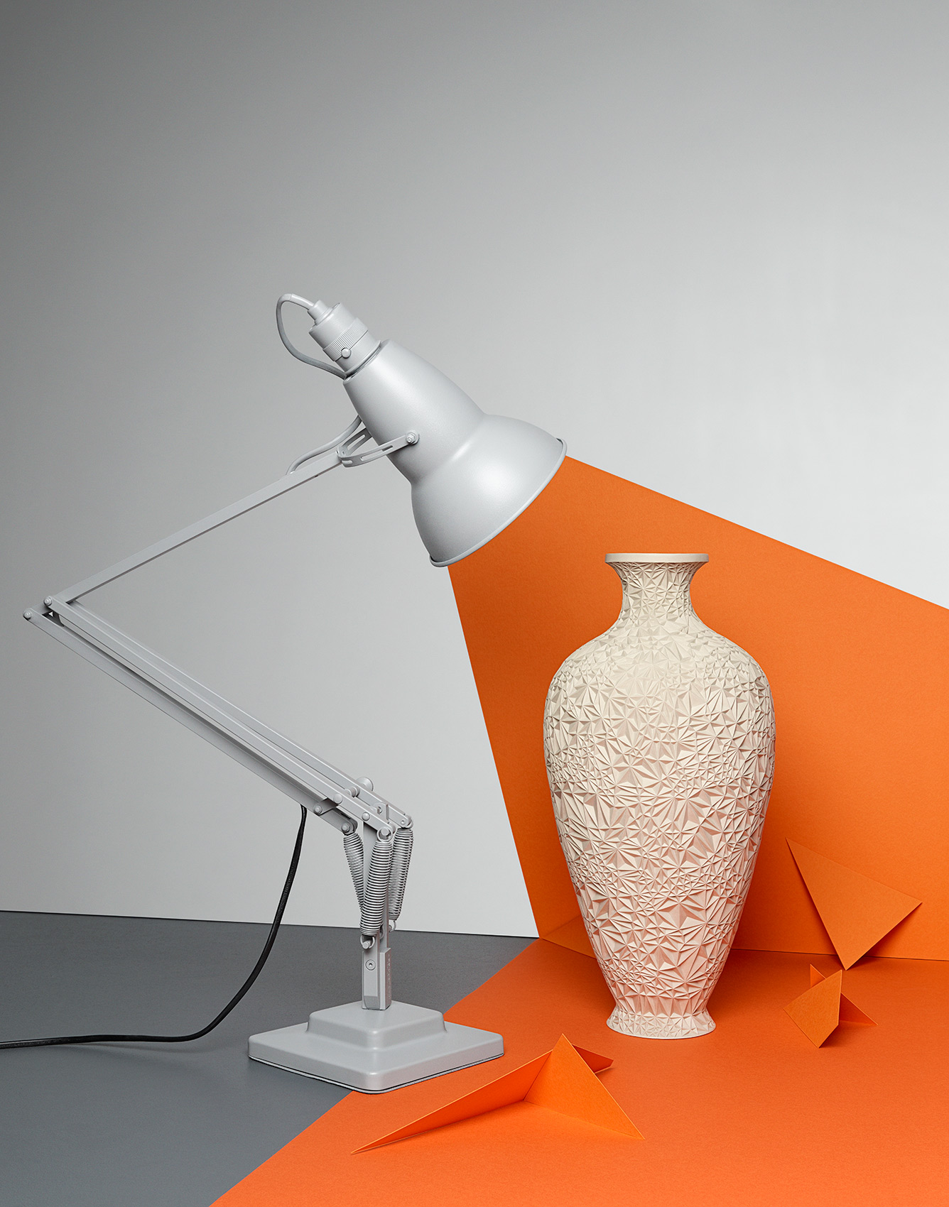 Orange beam of light coming from anglepoise lamp by Alexander Kent London based still life and product photographer.