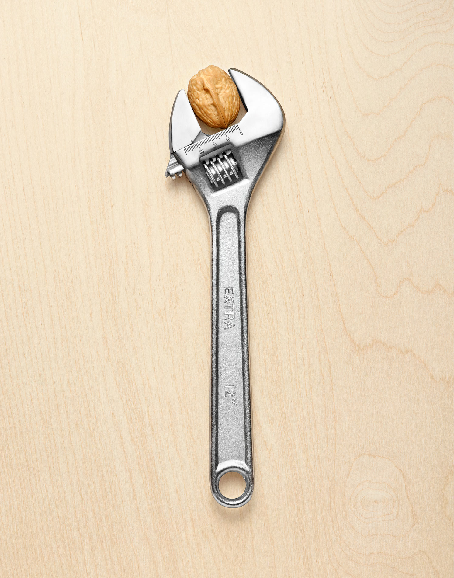 Walnut getting crushed in wrench by Alexander Kent London based still life and product photographer.