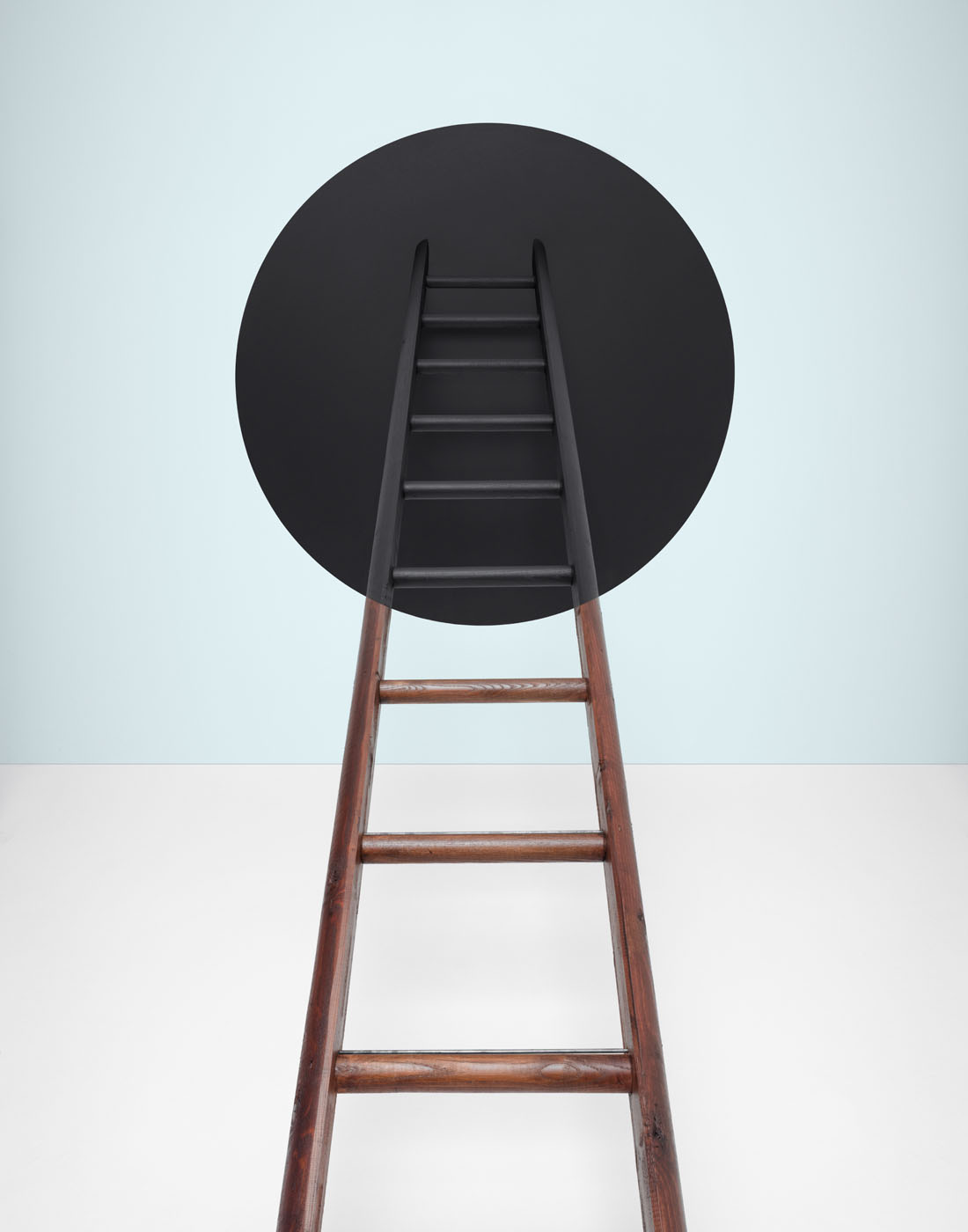 Ladder going into black hole in blue room by Alexander Kent London based still life and product photographer.