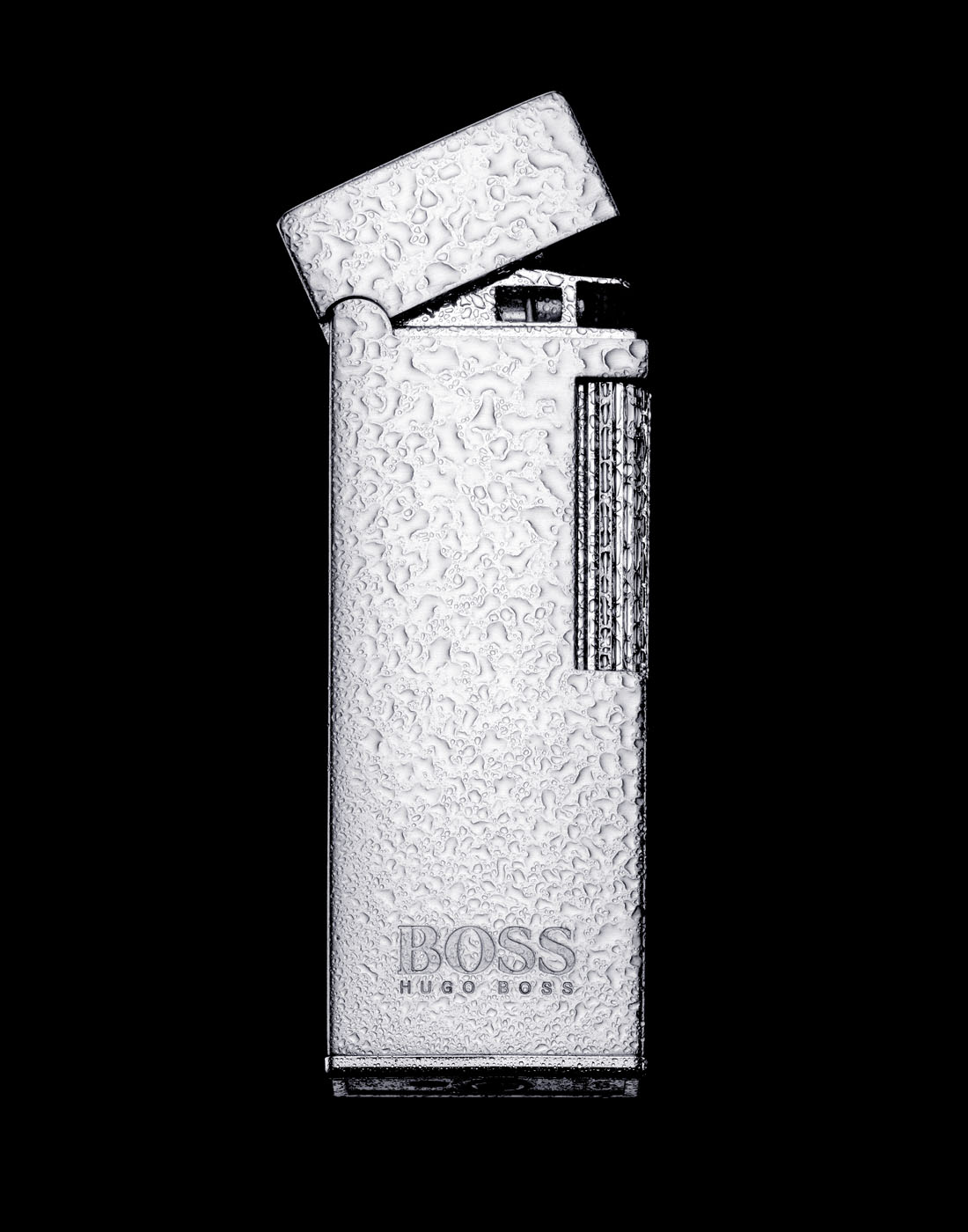 Hugo boss lighter with water by Alexander Kent London based still life and product photographer.