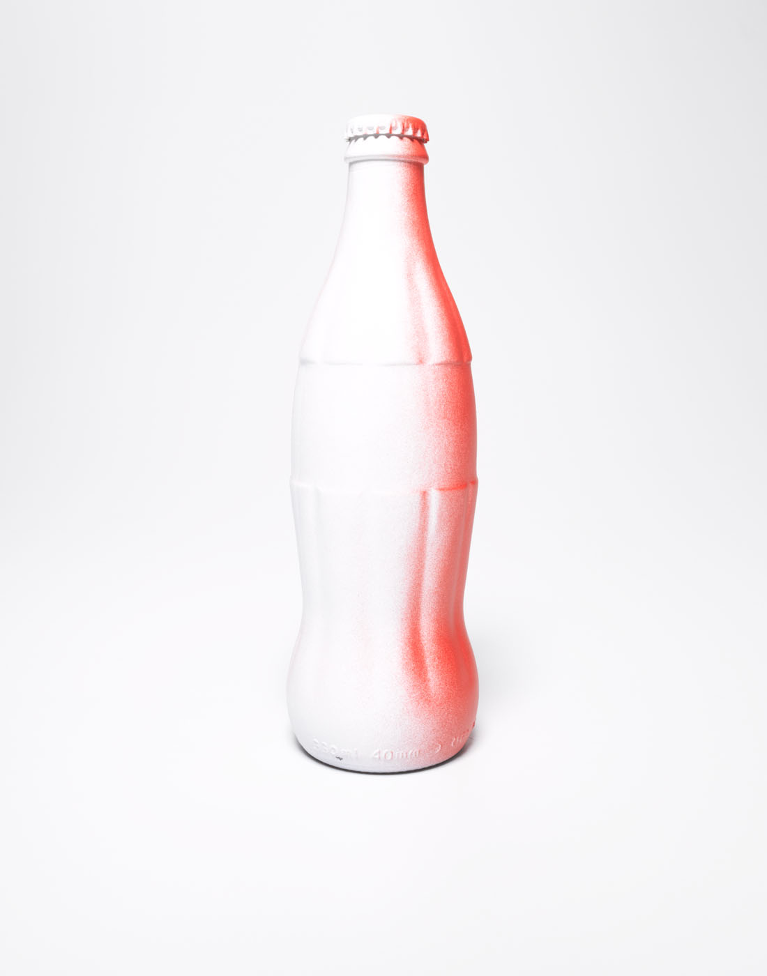 White cola bottle sprayed red by Alexander Kent London based still life and product photographer.