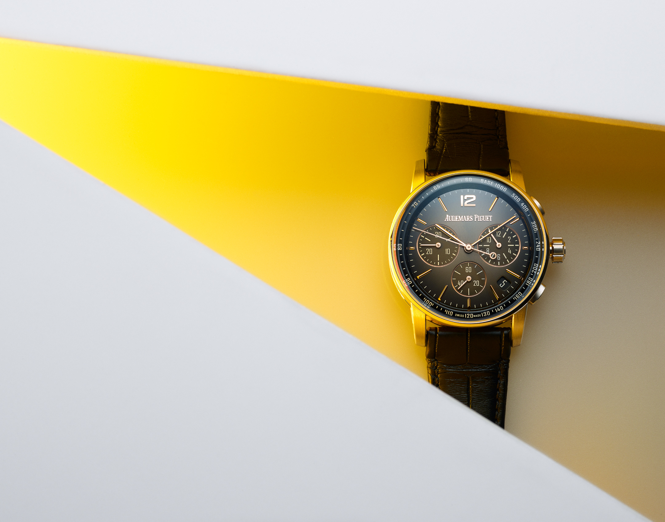 Audemars watch in yellow light beam by Alexander Kent London based still life and product photographer.