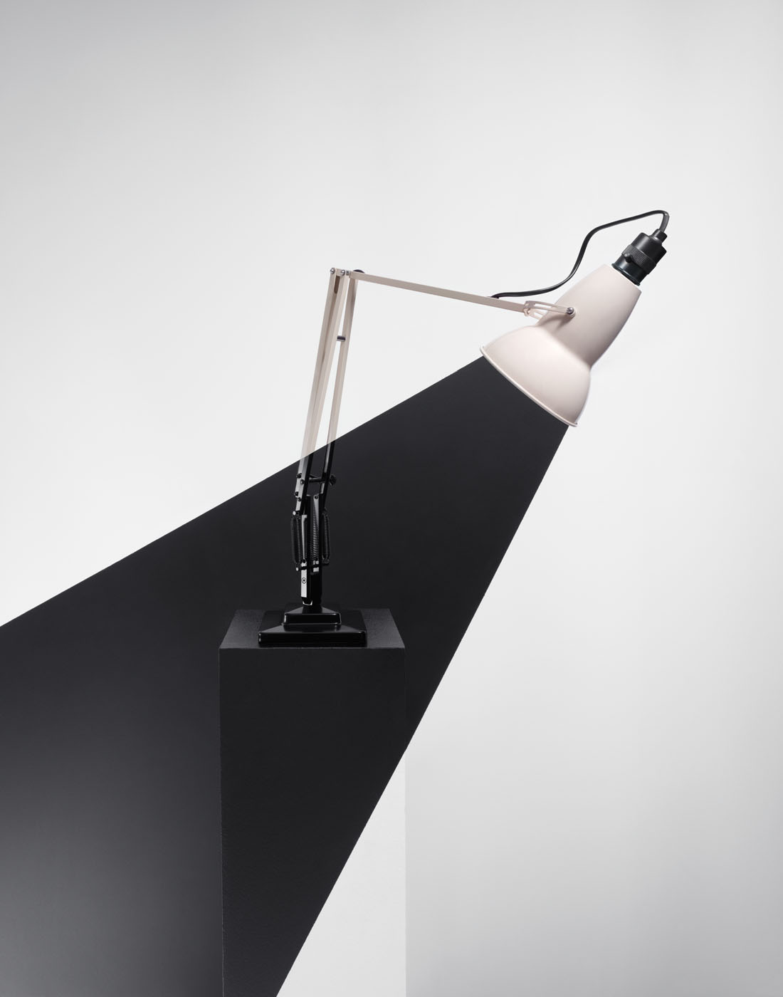 Black beam of light coming out of anglepoise lamp by Alexander Kent London based still life and product photographer.