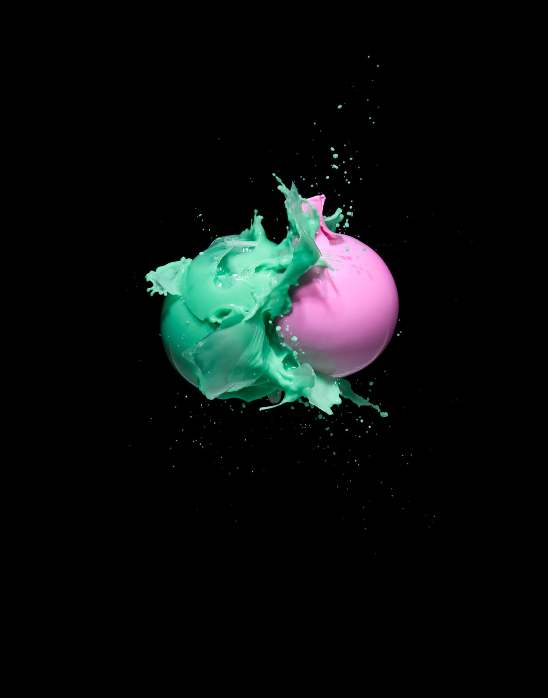 Green and pink paint explosion on black background by Alexander Kent London based still life and product photographer.