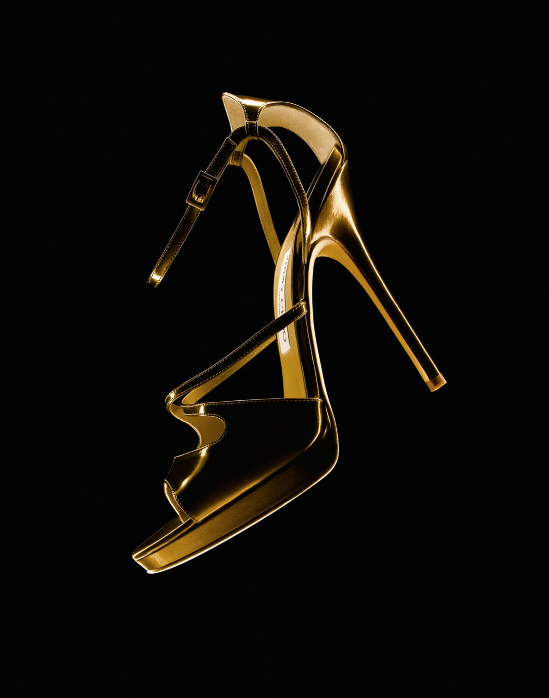 Gold shoe on black by Alexander Kent London based still life and product photographer.